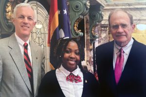 A teen poses with two older politicians