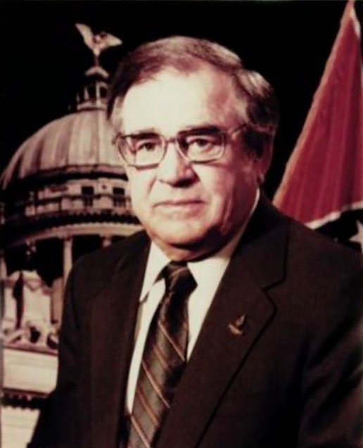 An old portrait of a man in front of the Mississippi capitol building